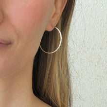Load image into Gallery viewer, Large round silver post hoop earring on woman