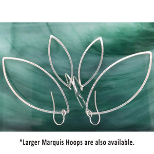 silver hammered leaf shaped hoops on ear wires in medium and large sizes on green background
