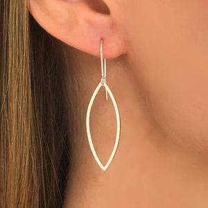 silver hammered leaf shaped hoops on ear wires on woman's ear